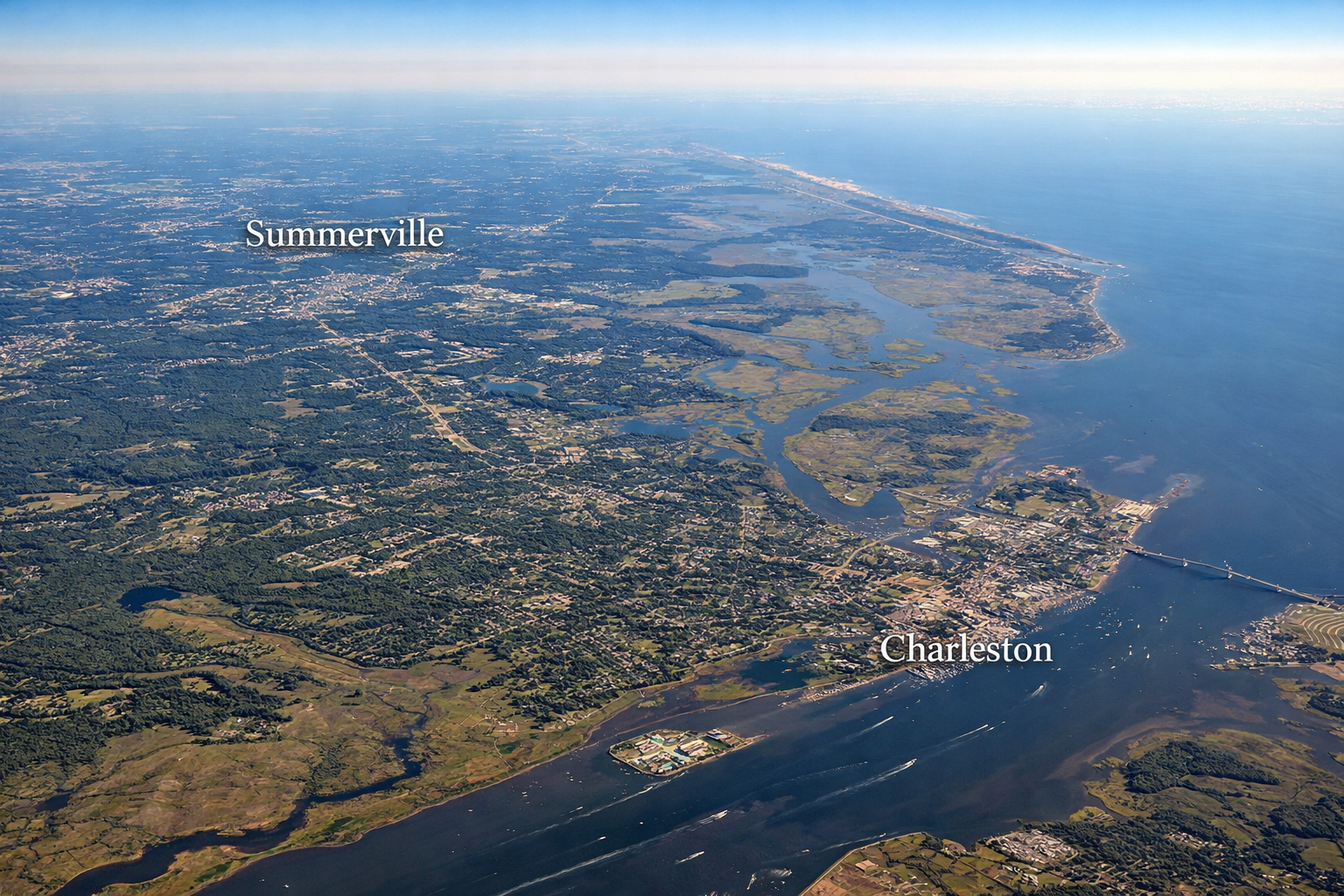 Aerial view from approximately 10,000 feet showing the Charleston, South Carolina region stretching from Summerville to downtown Charleston, including marshlands, waterways, residential communities, and the coastal landscape of the Lowcountry housing market.