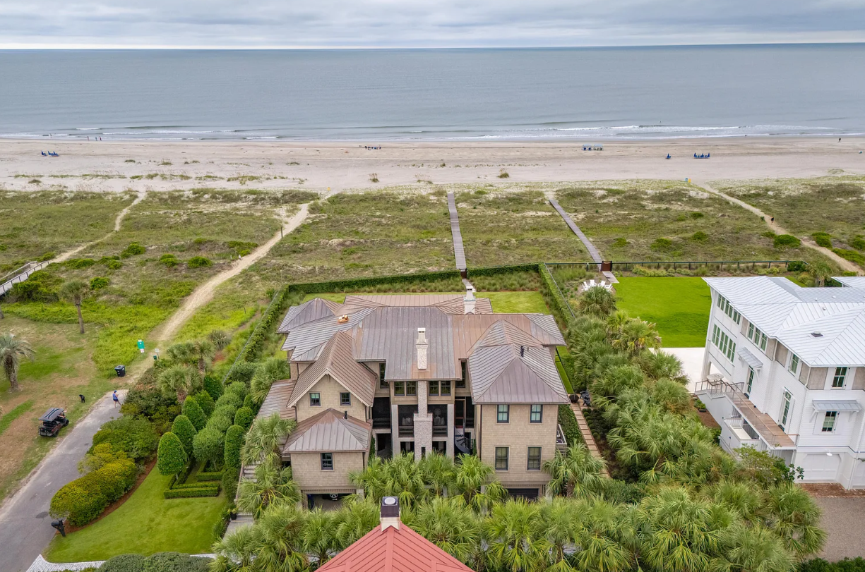 Aerial view of a luxury oceanfront home on Isle of Palms, South Carolina, with direct beach access and expansive Atlantic Ocean views
