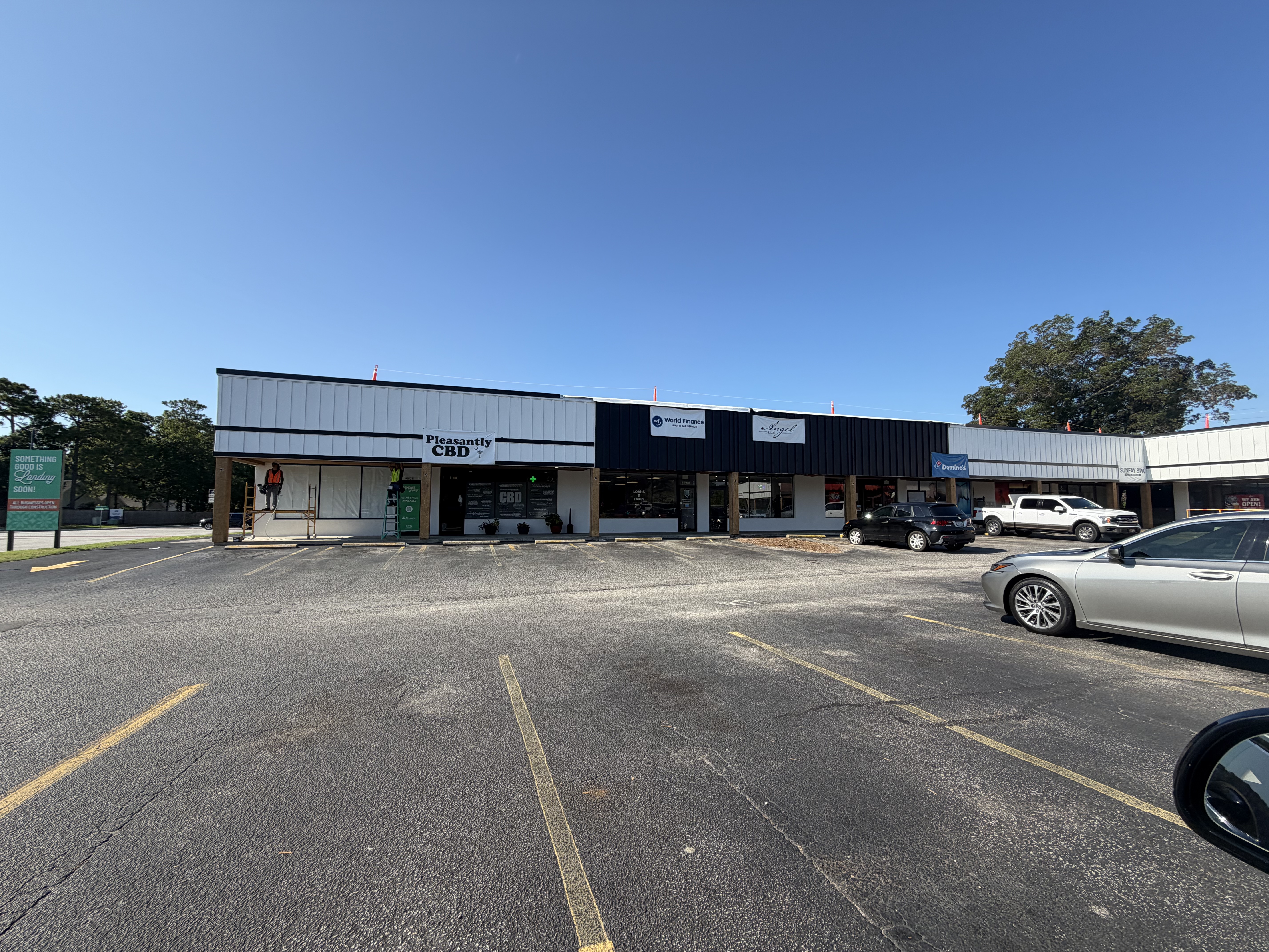 Renovated storefronts at Fairmount Shopping Center in Mount Pleasant, South Carolina, featuring updated facades, fresh exterior paint, and retail storefront improvements amid ongoing tenant turnover.