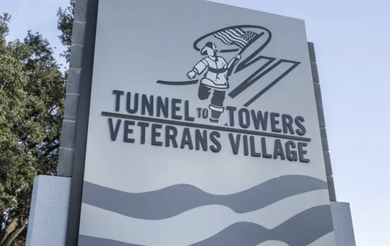 The entrance sign for Tunnel to Towers Veterans Village stands outside the newly opened affordable housing community for veterans in North Charleston, South Carolina.
